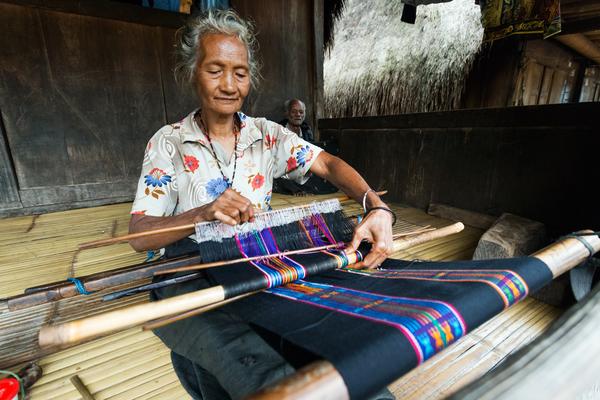 Elderly woman weaving an ikat in Bajawa, on the island of Flores, photo © Tony Prince via Shutterstock
